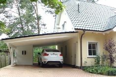 a white car parked in front of a house