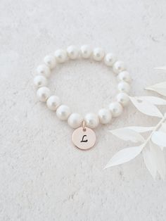 This sweet little pearl bracelet is personalised pearl to suit your bridal party. This bridal bracelet is made from 8mm glass pearls and 12mm rose gold plated initial disc. Your jewellery will arrive in a gift box ready for giving. This item ships from the UK within 1 working day. Please see size guide below: Sizes for children 3-6 months    4.25-4.5in 6-12 months    4.75in 12-24 months    5in 2-3 years    5.0-5.5in 4-5 years    5.75in 6-8 years    6in 9-13 years    6.25in Adult Sizes Small Adjustable Pearl Charm Bracelet For Bridesmaids, Adjustable Pearl Bracelet For Bridesmaids, Pearl Bracelet With Pearl Charm For Bridesmaids, Pearl Bracelet Bridesmaid Gift, Pearl Bracelets For Bridesmaid Gift, Pearl Beaded Bracelets With Pearl Charm For Bridesmaids, Adjustable Beaded Bracelets With Pearl Drop For Bridesmaid, Adjustable Pearl White Bracelet For Bridesmaids, Adjustable Pearl White Pearl Bracelet For Bridesmaids