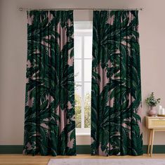 a living room with a large window covered in green palm leaf curtains and a rug on the floor