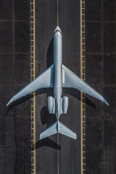 an airplane is flying low over the tarmac at an airport, overhead view from above