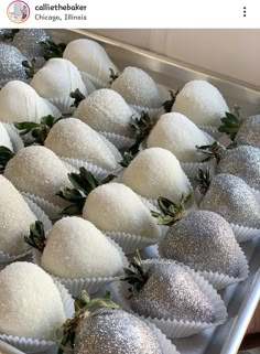 white chocolate covered strawberries are lined up on a tray with silver glittered decorations