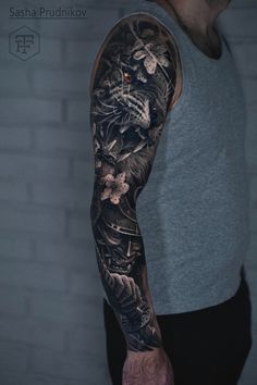 a man with a full sleeve tattoo on his arm