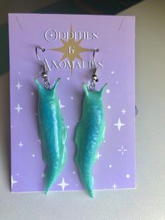 These slimy looking slugs are perfect for lovers of creepy crawlers. Charge them in the light and watch them glow!  I am able to make almost any color glow, so feel free to message me if you're interested in a custom order.  Please note:  All of my items are handmade to order. This means you will receive a unique, one-of-a-kind item that may differ slightly from the photos. Please allow extra processing time while I perfect your order! Creepy Clay Earrings, Polymer Clay Slug, Weird Clay Earrings, Cool Clay Earrings, Clay Slugs, Unique Polymer Clay Ideas, Polymer Clay Ideas Aesthetic, Clay Slug, Polymer Clay Bugs