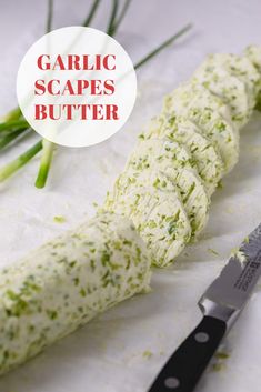 garlic scapes are cut into strips and placed on a cutting board with a knife