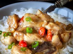 a white plate topped with rice and chicken