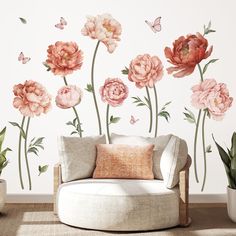 a living room with flowers and butterflies on the wall