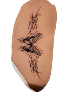 the back of a woman's shoulder with tattoos on her arm and butterfly wings