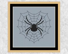 a cross stitch pattern with a spider on it