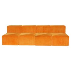 an orange couch sitting on top of a white floor