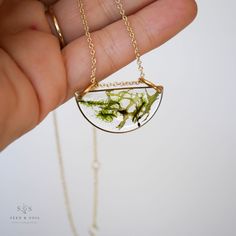 Our favorite Luna Necklace in our Woodland Collection finish. Featuring a variety of moss specimens for a beautiful layering of colors and textures. Moss symbolizes interconnectedness as well as the cycles of life. This half moon shape necklace somehow manages to be minimal while also being a unique statement piece. Chain is adjustable from 16"-18" and is gold plated over brass. Also available in a 20" length. Luna Necklace, Cycles Of Life, Cycle Of Life, Moon Shape, Moon Shapes, Half Moon, Chain Lengths, Statement Pieces, Layering