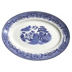 a blue and white plate with trees on it