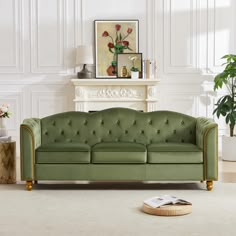 a green couch sitting next to a fireplace in a living room on top of a rug