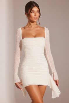 Designed in our fully embellished, dual lined mesh fabric, the Ferrara mini dress features a bust flattering cowl neckline, ruched bodice and delicate ruffle detailing. Cowl Neck Mini Dress, Birthday Plans, Oh Polly Dresses, Black Backless Dress, White Long Sleeve Dress, A Line Mini Skirt, Closet Inspiration, Grad Dresses, Ruched Bodice