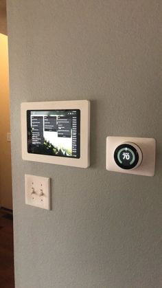 two buttons on the side of a wall with an appliance attached to it