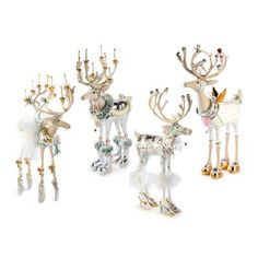 four different types of reindeer figurines are shown in this image, one is white and the other is gold