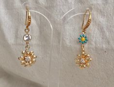 🌸 SPRING GLAM 🌸 Fresh flowers for spring A pair of Beautiful gold flower earring You can choose between a few finishes: 🌼 Dangle gold flower - The gold flower charm size about 10mm/1.5cm Round.It's made out of 2micron 14k gold plated with tiny Chz crystals In the shape of tiny flower in the middle. 🌼 Dangle 2 flowers - A colorful enameled flower with one of the colors available holding the gold flower. The tiny enameled flower size about: 0.5mm/1cm round. 🌼 Dangle gold flower and round diam Gold Earrings With 3d Flowers For Spring, Dainty Dangle Earrings For Spring, Dainty Spring Dangle Earrings, Spring Dainty Dangle Earrings, Gold Dangle Flower Earrings For Spring, Gold Flower Earrings With Lever Back, Gold Dangle Earrings With Flower Decoration, Dainty Flower Earrings For Spring Wedding, Dainty Spring Flower Earrings For Wedding