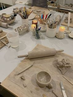 a table topped with lots of different types of pottery