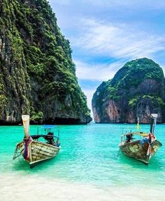 two boats are sitting in the clear blue water