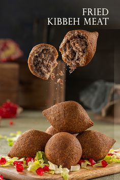 fried kibbeh meat on a cutting board with the words fried kibbeh meat above it