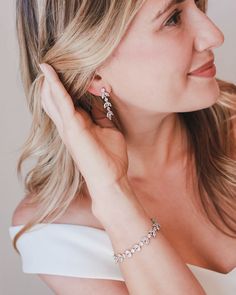 One of our most popular styles, our Sydney Floral CZ Earrings are handcrafted with CZ stones in a floral design. Artfully designed, you'll want to wear these earrings long after your wedding day. Cubic zirconias. Measures 1.25" long Available in pierced or clip version Matching bracelet available Hypoallergenic, lead-free & nickel-free Style #4140 Photo Credit: Han Designed & Hunter Hennes Photography Glamorous Cubic Zirconia Flower Earrings For Gift, Glamorous Flower Earrings With Cubic Zirconia For Gift, Diamond White Diamond Flower Earrings For Wedding, Elegant Design Cubic Zirconia Diamond Earrings For Gift, Elegant Cubic Zirconia Diamond Earrings For Gift, Cubic Zirconia Flower Earrings For Wedding, Formal Cubic Zirconia Flower Drop Earrings, Wedding Flower Earrings With Sparkling Cubic Zirconia, Elegant Cubic Zirconia Bridal Earrings For Anniversary