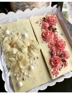 two pieces of cake decorated with flowers and pearls