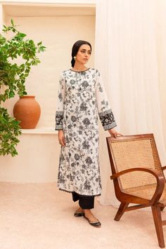 BATIK Zahviya 2Pc - Printed Lawn Dress Ready to wear 2pc dress Flaunt this artfully printed set made from our premium quality Pima lawn in the shades of pearl white. Elegantly printed paneled shirt comes with an embellished neckline - details include lace finishing at neckline and hem. Sleeves are loose fit, adorned with contrasting printed border – finished with lace. Paired with dyed cambric trousers. Disclaimer: Colors may slightly vary due to lighting Premium quality Pima lawn Embellished ne Spring Tunic Sets With Digital Print, Spring Printed Tunic Sets, Eid Digital Print Straight Kurta Dress, Eid Straight Kurta Dress With Digital Print, Eid Straight Kurta With Digital Print, Traditional White Dress With Digital Print, Traditional Long Sleeve Dress With Digital Print, White Digital Print Kurta For Spring, Elegant White Printed Kurta