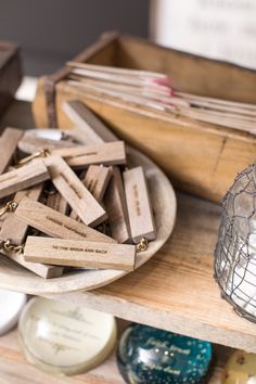 several wooden pieces are sitting on a table next to a wire basket and other items