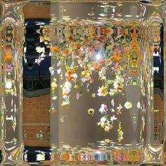 a mirror with flowers hanging from it's sides