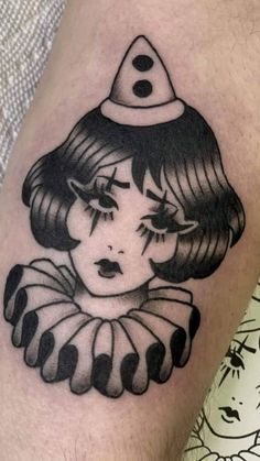 a woman's leg with a black and white tattoo design on her thigh, wearing a hat