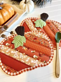 two placemats on a table with pumpkins and other decorations in the background