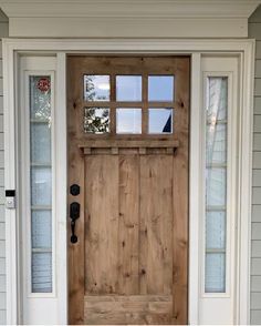 the front door is made from wood and has two sidelights on each side,