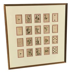 a framed art work with playing cards on it