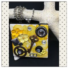 a yellow and white purse with lots of different things on it