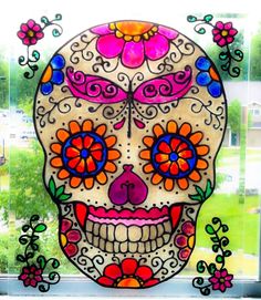 a colorful sugar skull with flowers on it's head is shown in front of a window