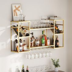 a shelf filled with wine glasses and liquor bottles