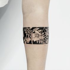 a woman's leg with a black and white flower tattoo on it