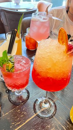 two drinks sitting on top of a wooden table