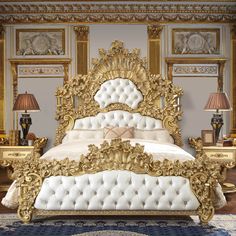 an ornate gold and white bed in a bedroom