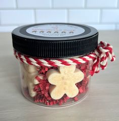 a jar filled with red and white candy canes