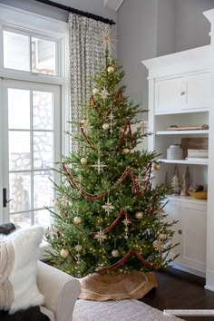 a living room with a christmas tree in the corner