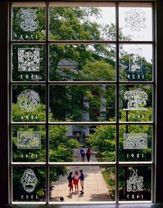 an image of people walking in the park through a window with numbers and symbols on it