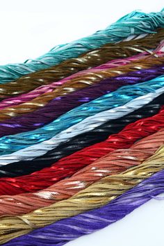 many different colored braids on a white surface