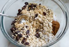 oatmeal and raisins are mixed in a glass bowl