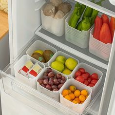 an open refrigerator filled with lots of different types of fruits and vegetables in plastic containers