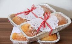 three pieces of bread wrapped in paper and tied with red ribbon on top of each other