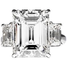 an emerald cut diamond ring with three baguets