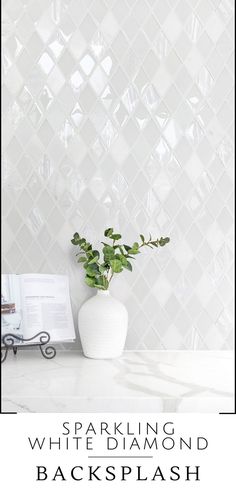 a white vase with a green plant in it and the words sparkling white diamond backsplash