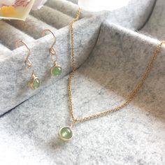 This beautifully simple necklace and earring set is lovingly handmade with tiny Peridot gemstones and a choice of 14k Gold Filled, 14k Rose Gold Filled or Sterling Silver finish. M A T E R I A L S: * Peridot * 14k Gold Filled, 14k Rose Gold Filled or Sterling Silver Chain & Hooks S I Z E: *  Gemstones - Approximately 4mm *  Chain Thickness - Approximately 1.1mm  All of our jewellery is carefully handmade using good quality materials and handpicked gemstones, with the aim to produce quality pieces that you can love & wear for years to come.  P E R I D O T: * August Birthstone * Talisman for Gemini, Leo, Virgo, Scorpio, Sagittarius  * Heart Chakra, Solar Plexus Chakra Peridot is a powerful cleanser.  It alleviates jealousy, resentment, spite, bitterness, irritation, hatred and greed.  Reduce Handmade Gold Plated Jewelry For May Birthstone, Nickel Free Yellow Gold Jewelry For May Birthstone, Nickel-free Yellow Gold Jewelry For May Birthstone, Nickel-free Yellow Gold May Birthstone Jewelry, 14k Gold Dangle Jewelry For May Birthstone, Minimalist Dangle May Birthstone Jewelry, Yellow Gold Jewelry With Matching Earrings For May Birthstone, Handmade Minimalist Jewelry For May Birthstone, Minimalist May Birthstone Dangle Jewelry