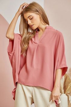 This casual oversized blouse comes with a split neckline and voluminous dolman sleeves for a relaxed but chic look. The ruffled detailing at the back gives it a little extra flair and femininity while still being easy to pair with your favorite jeans. Simply throw it on for a effortlessly stylish weekend ensemble that's perfect for coffee dates or running weekend errands. 100% Rayon Flowy V-neck Top For Work, Chic V-neck Tunic For Spring, Trendy Oversized V-neck Blouse, Chic Relaxed Fit V-neck Top For Day Out, Chic V-neck Blouse With Relaxed Fit, Oversized Versatile V-neck Blouse, Versatile Oversized V-neck Blouse, Chic Split Neck Top For Day Out, Billowy Feminine V-neck Top