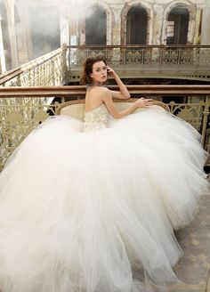 a woman in a white dress sitting on a chair